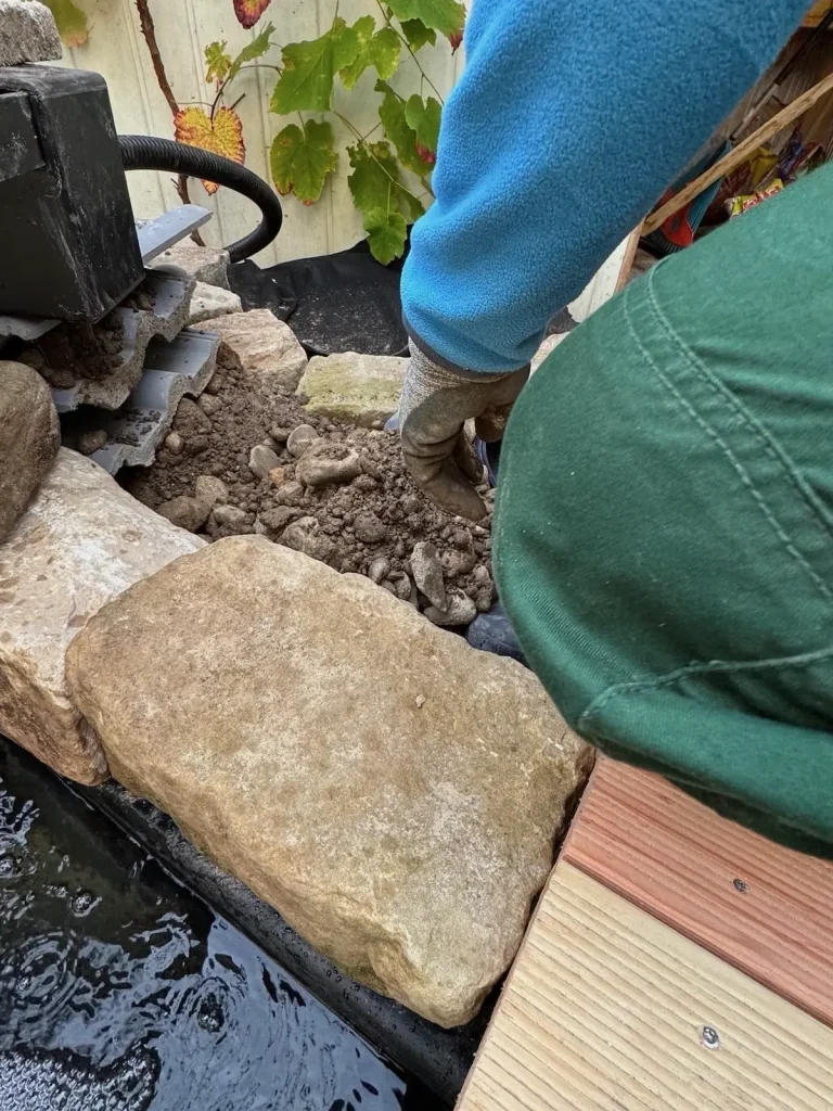 Montagearbeiten im Garten im Rahmen eines Mini-Teich-Projekts